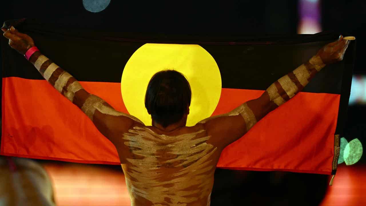 An Indigenous performer with a flag (file image)