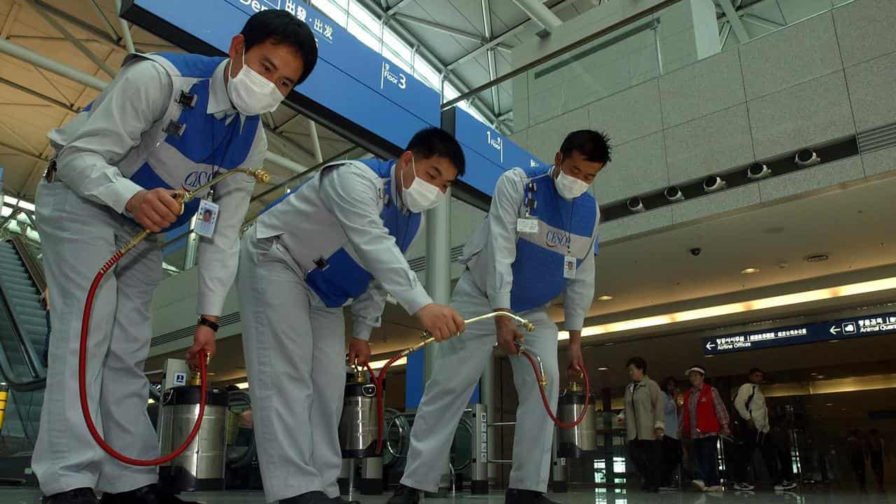 Workers disinfect a South Korean airport (file image)