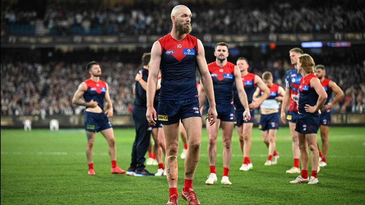 Melbourne players leave the field after their AFL semi-final loss.