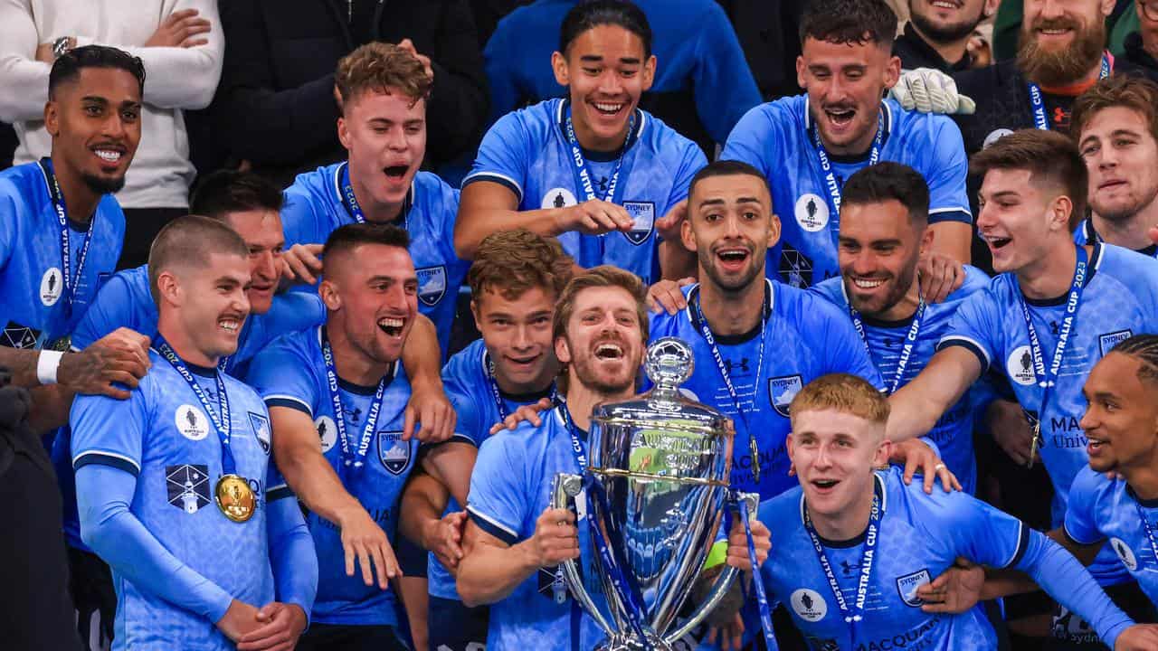 Sydney FC players celebrate with the Australia Cup.