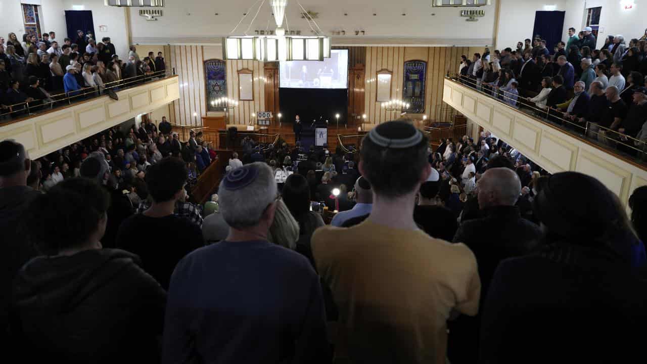 People gather during a vigil