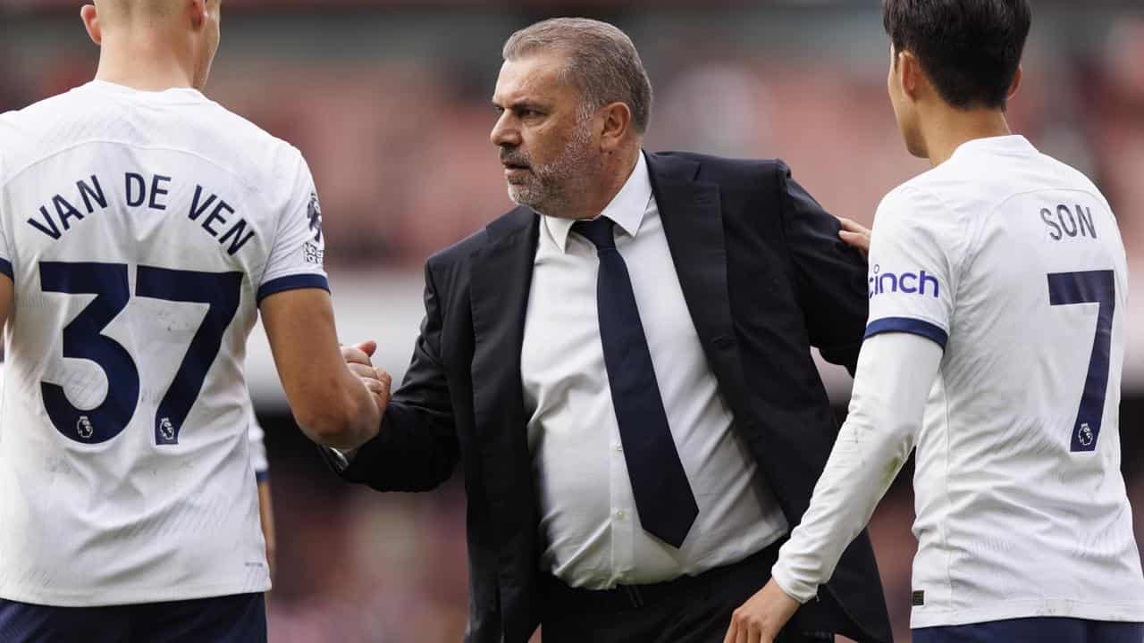 Ange Postecoglou with two of his Spurs players.