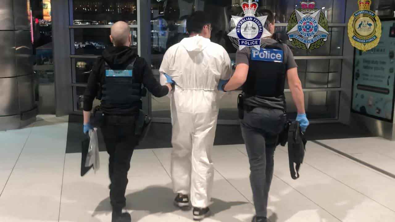 Federal and Victorian police arresting a man at Melbourne Airport