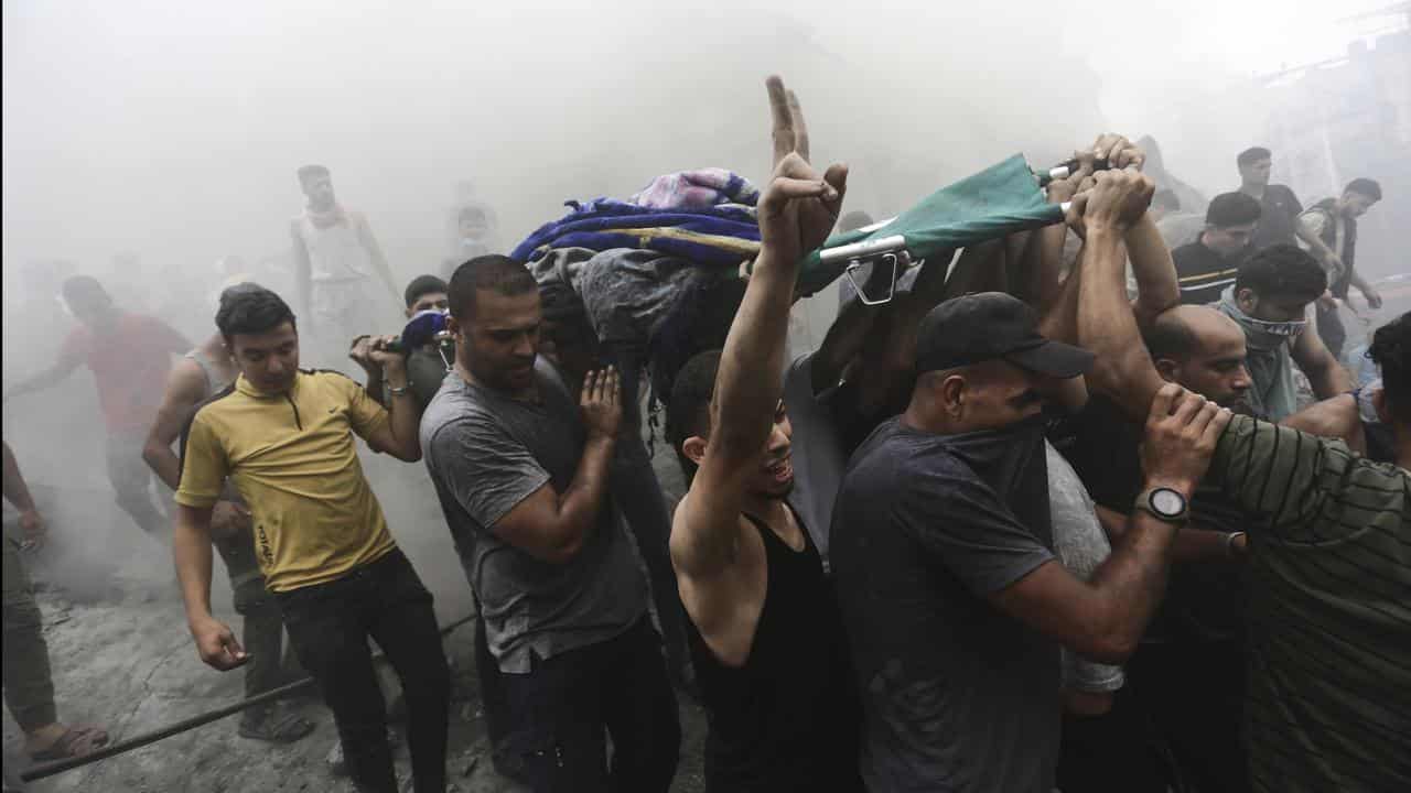 Palestinians remove body from rubble in Gaza refugee camp