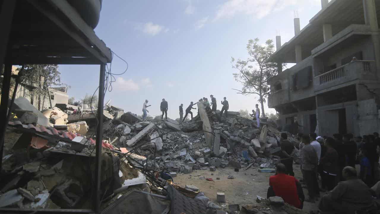 Palestinians at a building destroyed in an Israeli airstrike in Rafah.