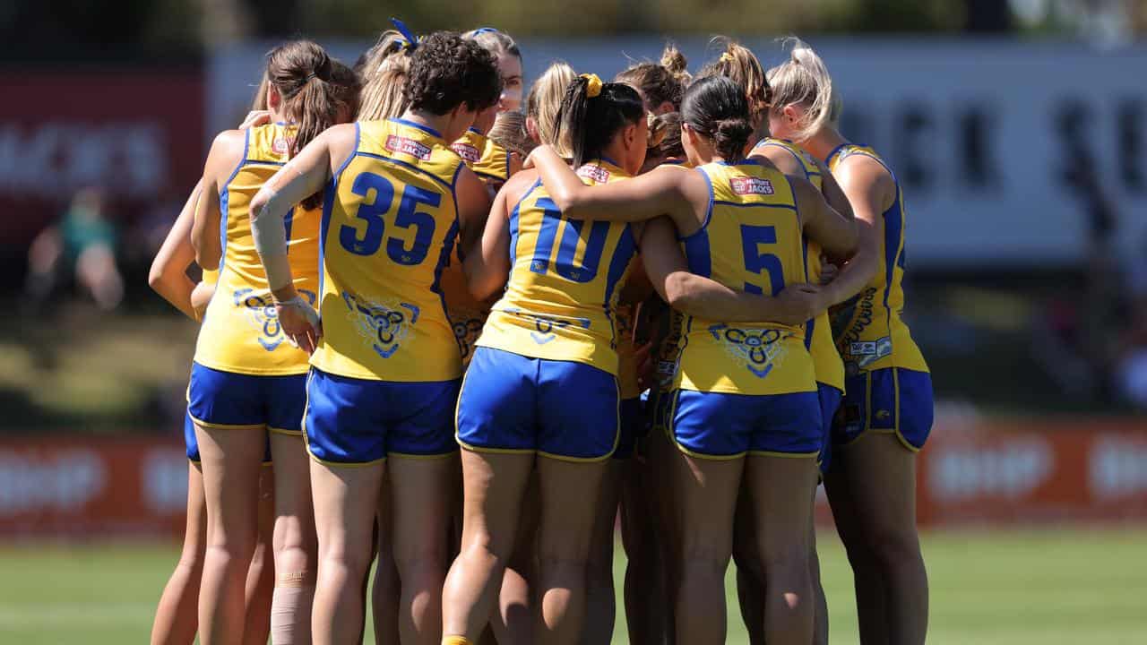 West Coast players huddle.