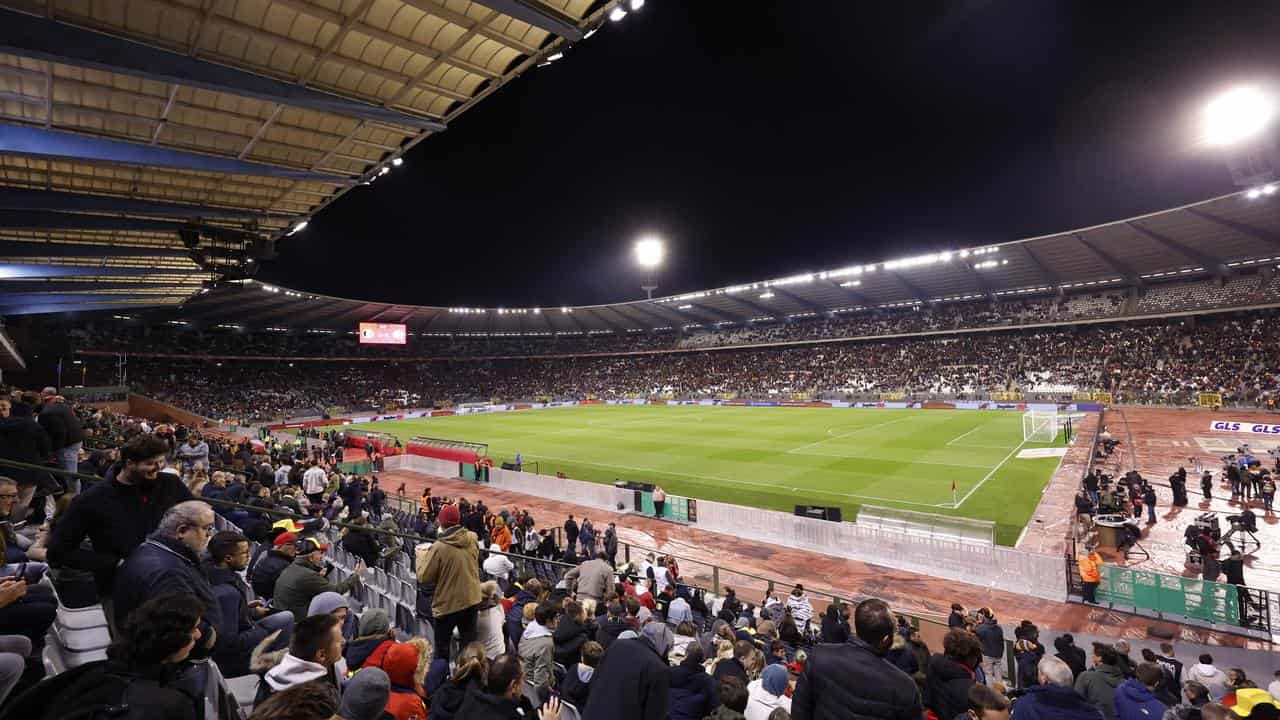 Supporters wait on the stands at King Baudouin Stadium in Brussels