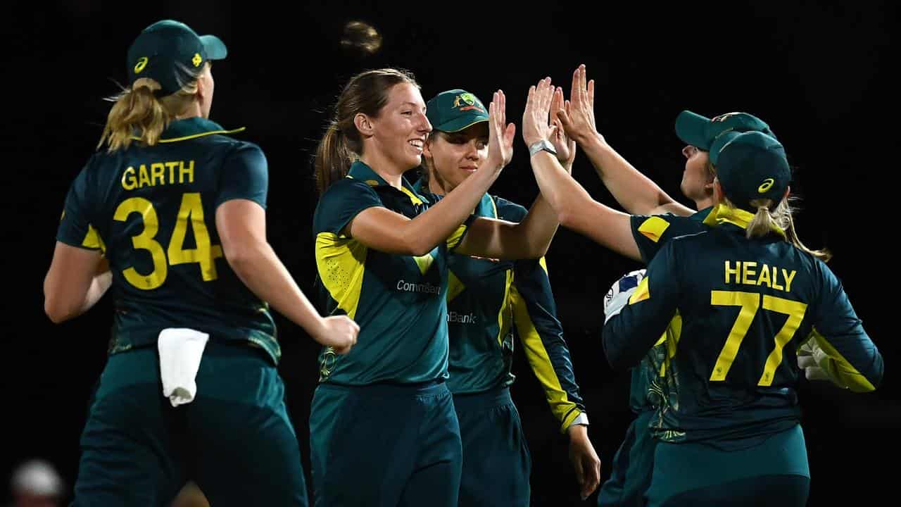 Australia's women's cricketers celebrate a wicket. 