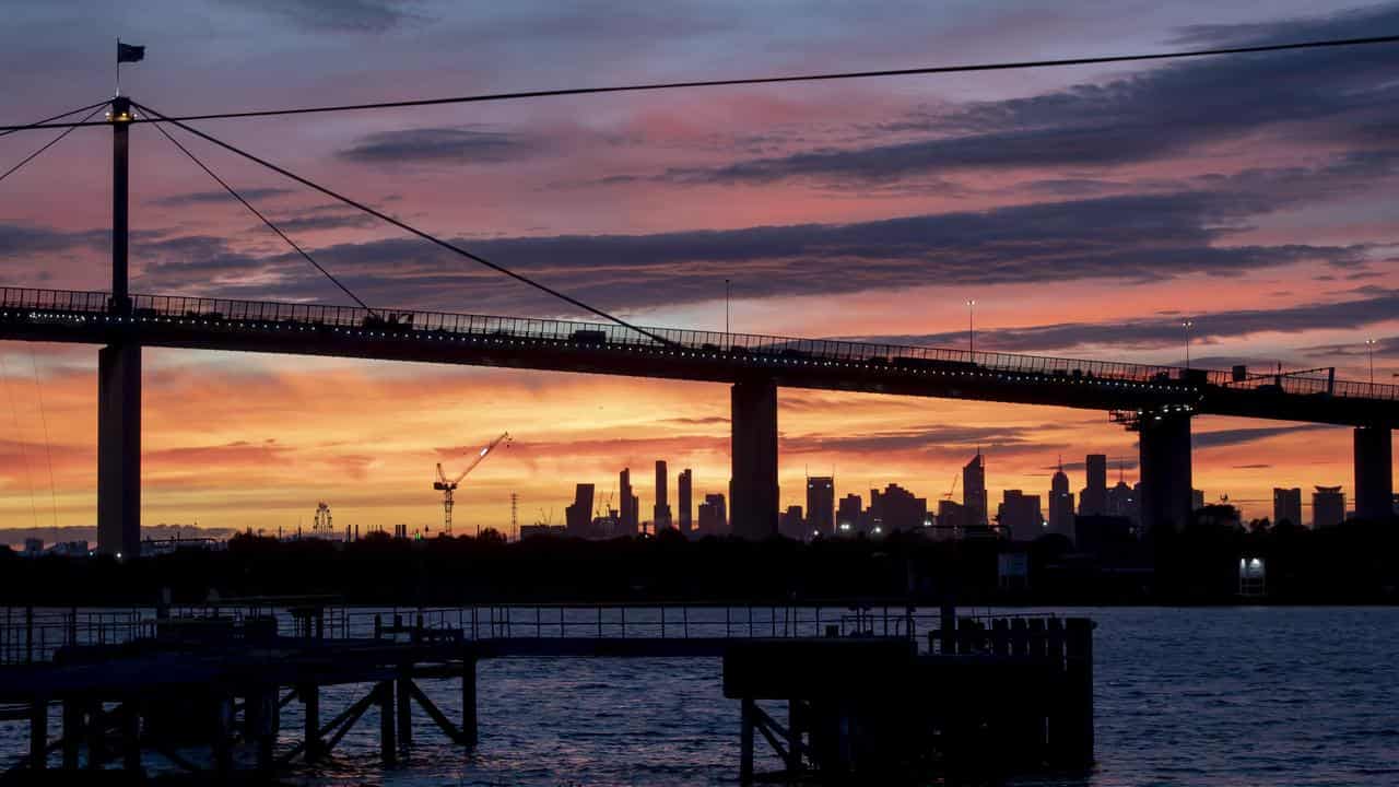 The West Gate Bridge and the city of Melbourne skyline at sunrise