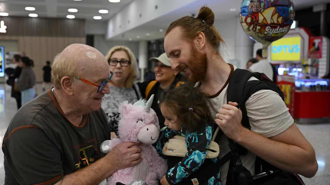 Michael and Leemore Landis and their daughter Libby are welcomed home