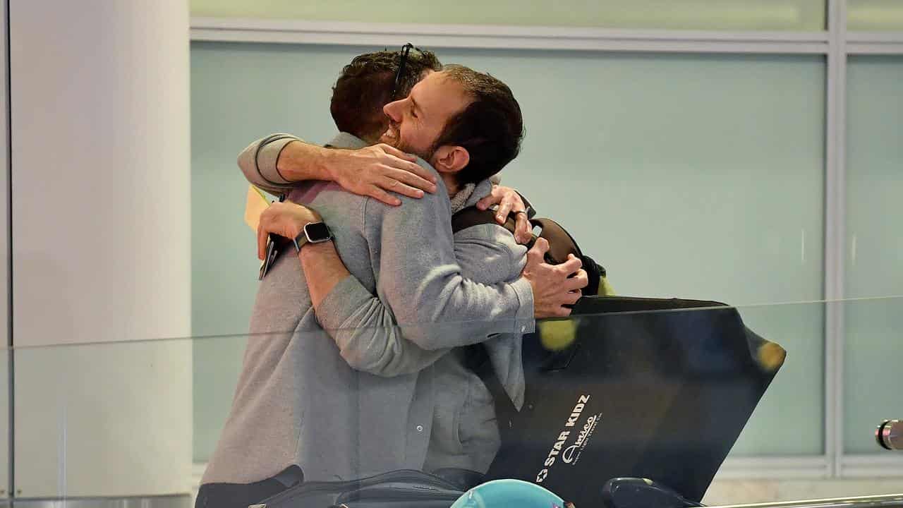 People embrace at Sydney Airport (file image)