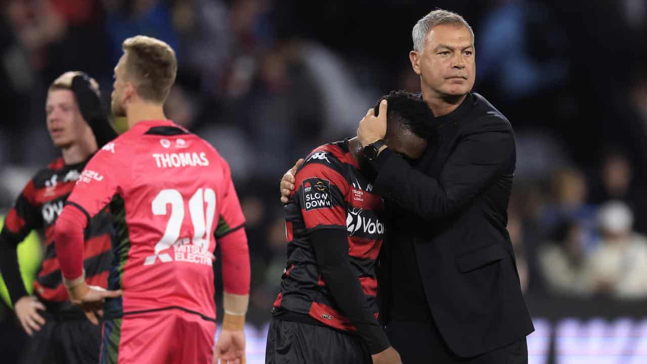 Wanderers coach Marko Rudan consoles Yeni N’gbakoto.