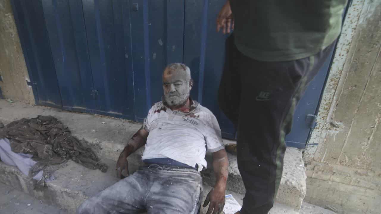 A Palestinian man lies wounded 