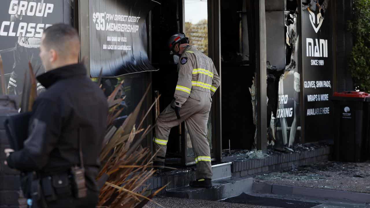 A firefighter at the gym with windows blown out