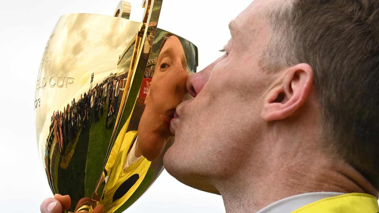 Without A Fight's jockey Mark Zahra embraces the Caulfield Cup.