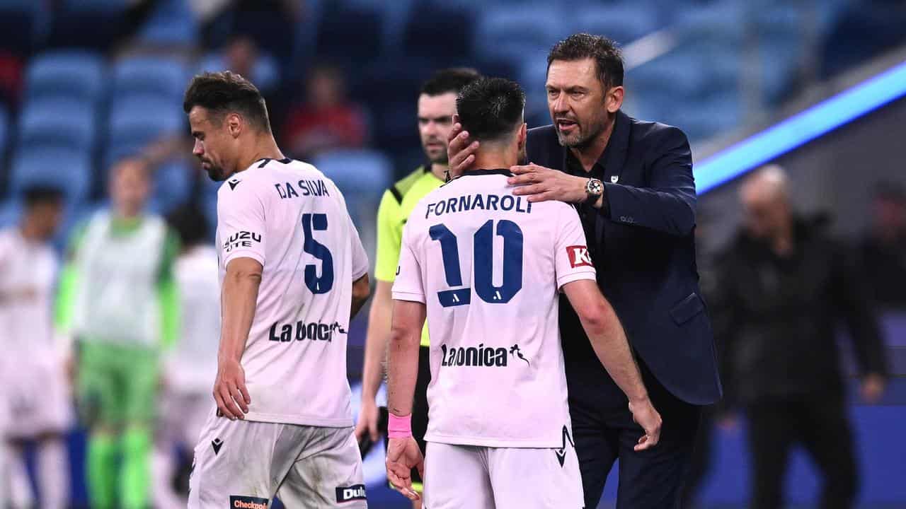 Goalscorer Bruno Fornaroli is congratulated by coach Tony Popovic. 