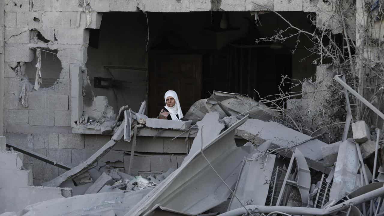 A Palestinian woman after an Israeli strike on the Gaza Strip