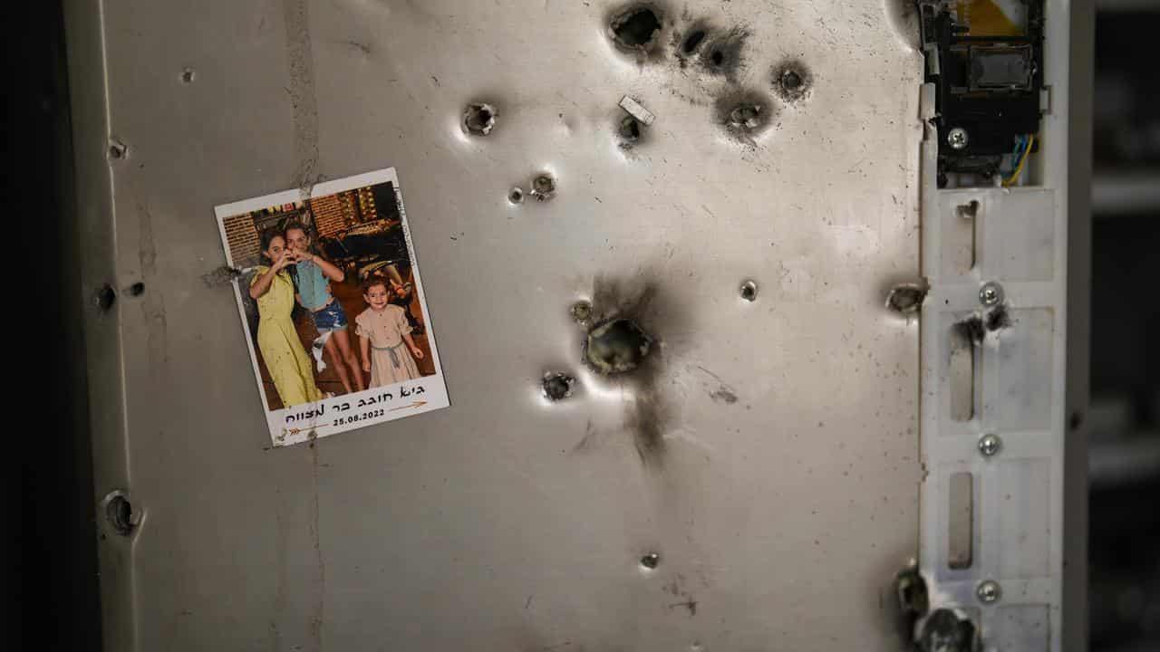 Photo hangs next to bullet holes at a home in southern Israel.