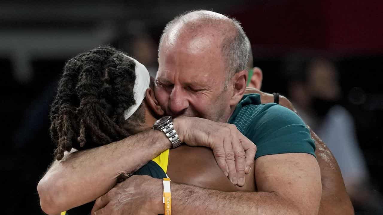 Patty Mills and Brian Goorjian hugging at the Tokyo Olympics.