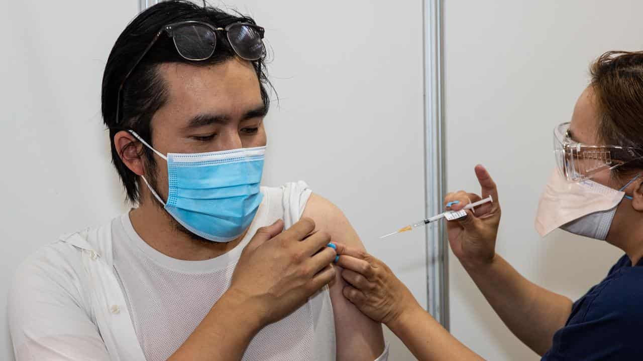 A health worker administers a COVID vaccine (file image)