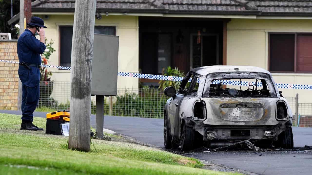 A burnt-out vehicle, believed to be the getaway car, in Sydney