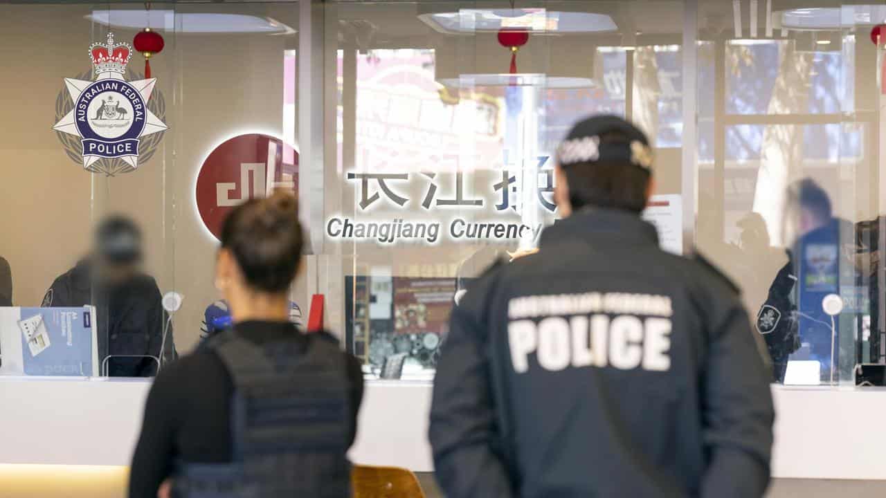 AFP officers at a shop front in Sydney