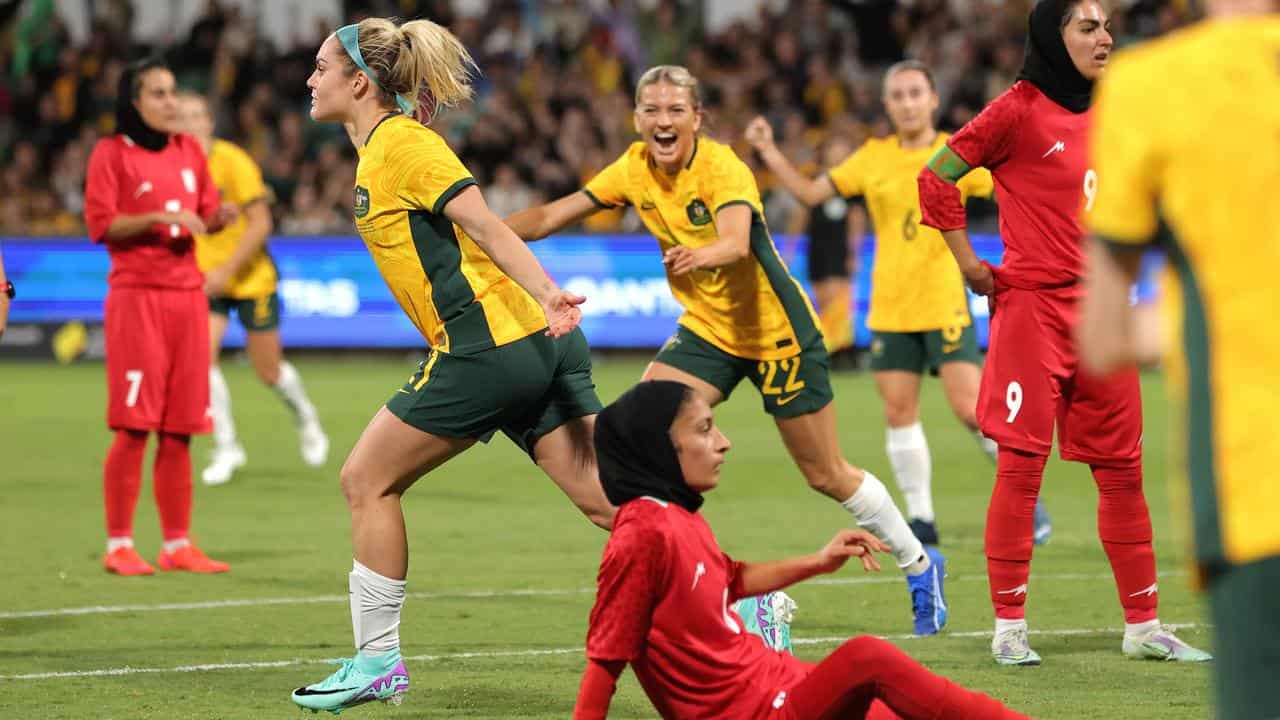 Ellie Carpenter celebrates scoring against Iran.