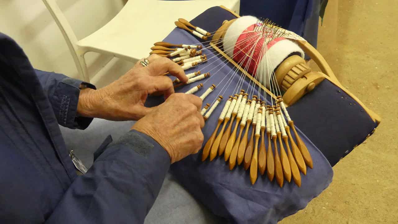 Orange lace maker Sandy Taylor at work