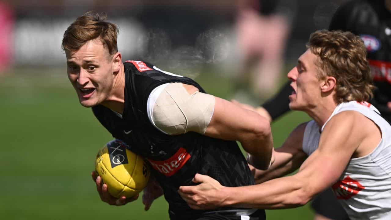 Collingwood AFL player Nathan Kreuger (left) 