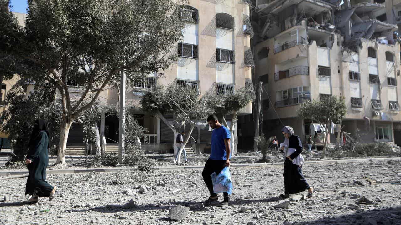 Palestinians leave their homes following Israeli strikes on Gaza City