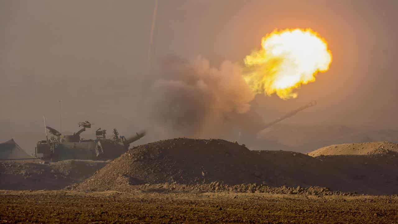 Israel Defense Forces fire a howitzer