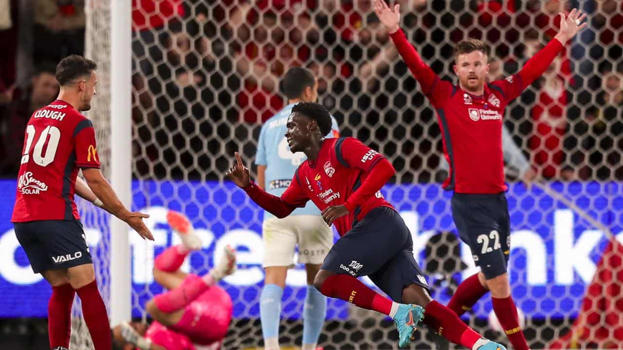 Musa Toure celebrates a goal for Adelaide against Melbourne City.