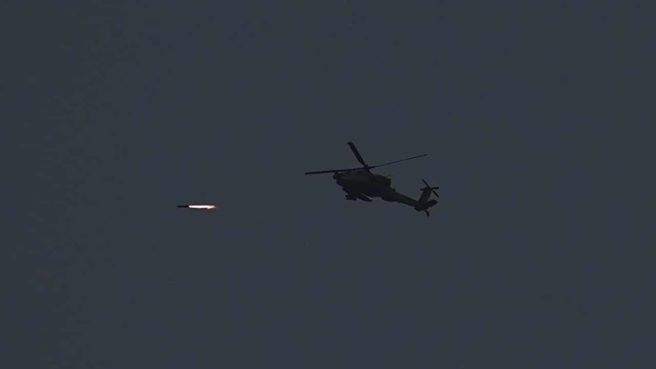 Israeli Apache helicopter fires a missile towards the Gaza Strip