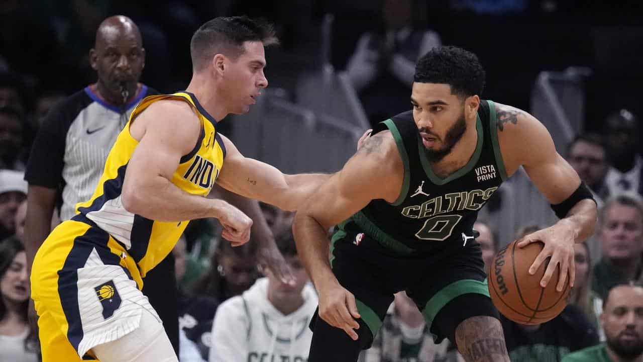 Boston Celtics' Jayson Tatum (right) against Indiana's TJ McConnell.