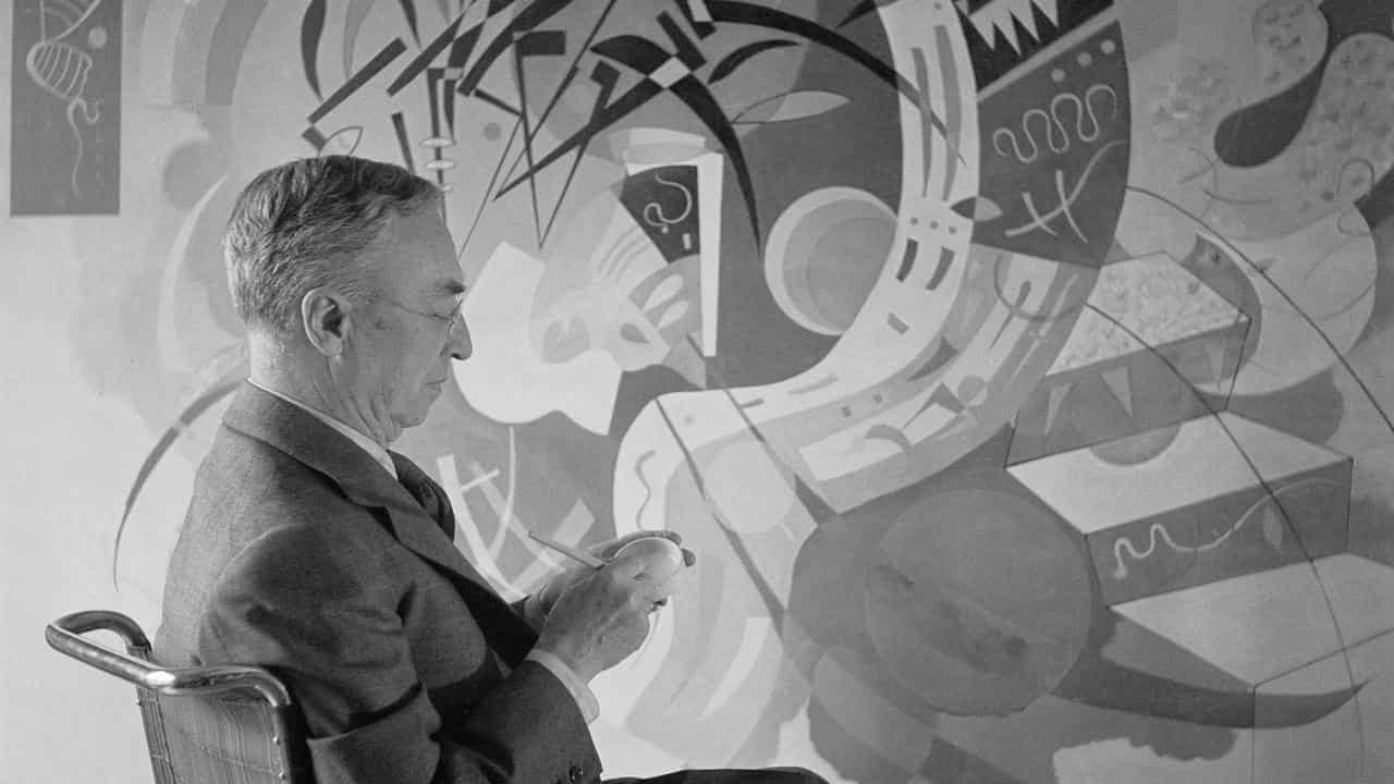 Kandinsky with his painting 'Dominant Curve in Paris, 1936