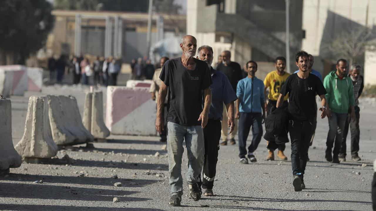 Palestinian day labourers in Israel arrive in the Gaza Strip