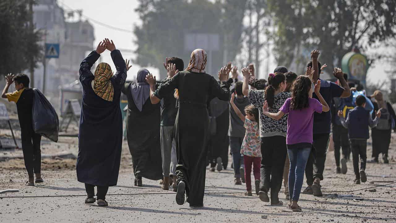 Civilians with their hands up evacuating from the northern Gaza strip