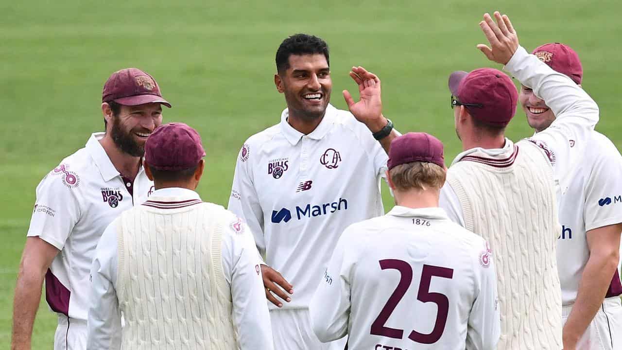 Queensland's Gurinder Sandhu celebrates bowling Jake Carder.