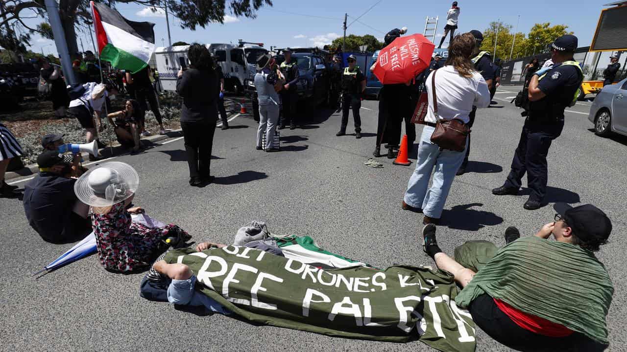 Pro-Palestine protesters block a road outside Flemington Racecourse