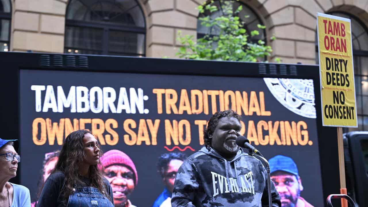 Bradley Farrar addresses protesters gathered outside the Tamboran AGM