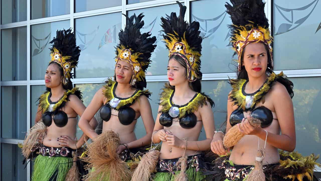 Women in traditional costume wait for Anthony Albanese in Rarotonga