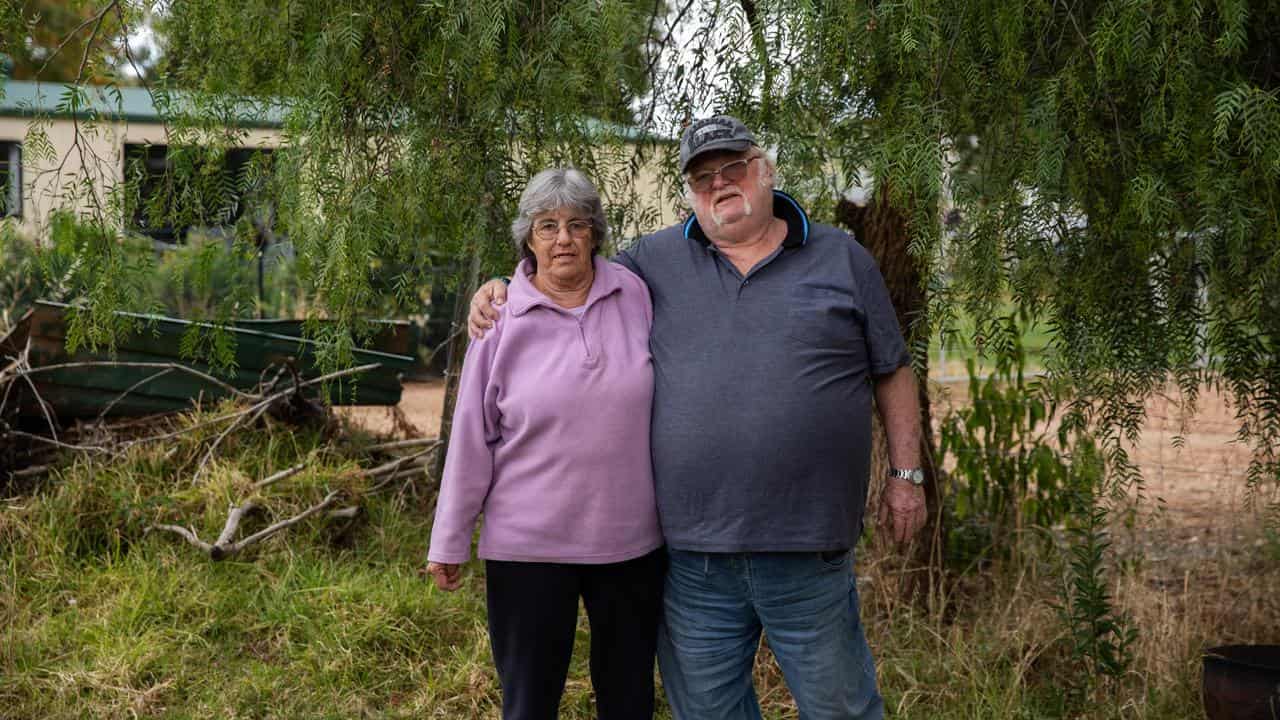 Cherie and Raymond Bennett in front of the tree that saved their lives