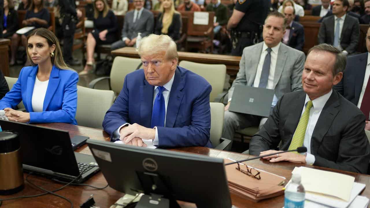 Donald Trump flanked by defence lawyers Alina Habba and Chris Kise