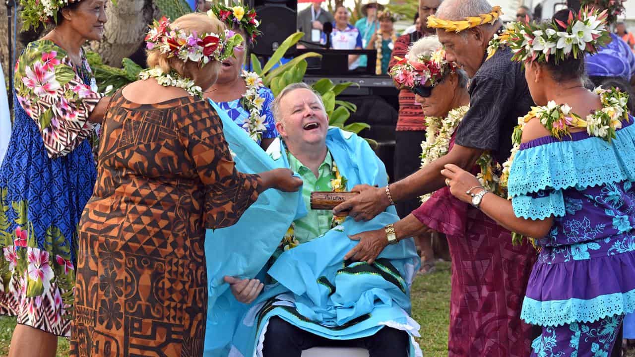 Prime Minister Anthony Albanese receives a gift of a handmade quilt