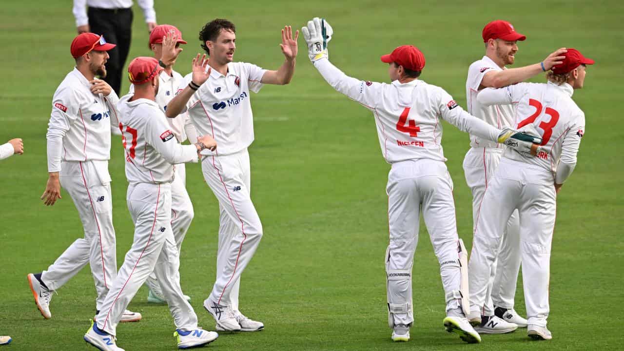 South Australian teammates congratulate Jordan Buckingham (centre)