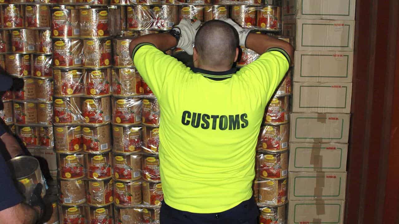 Customs with tins filled with ecstasy tablets (file image)