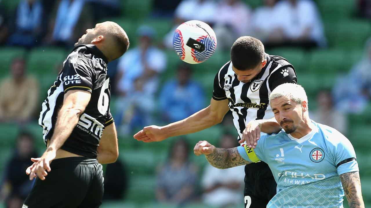 Players from both sides compete for a header.