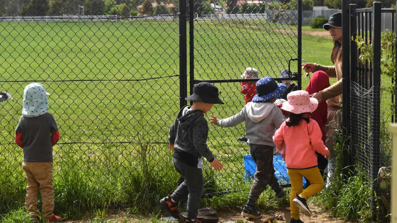 Children play outside a childcare centre.