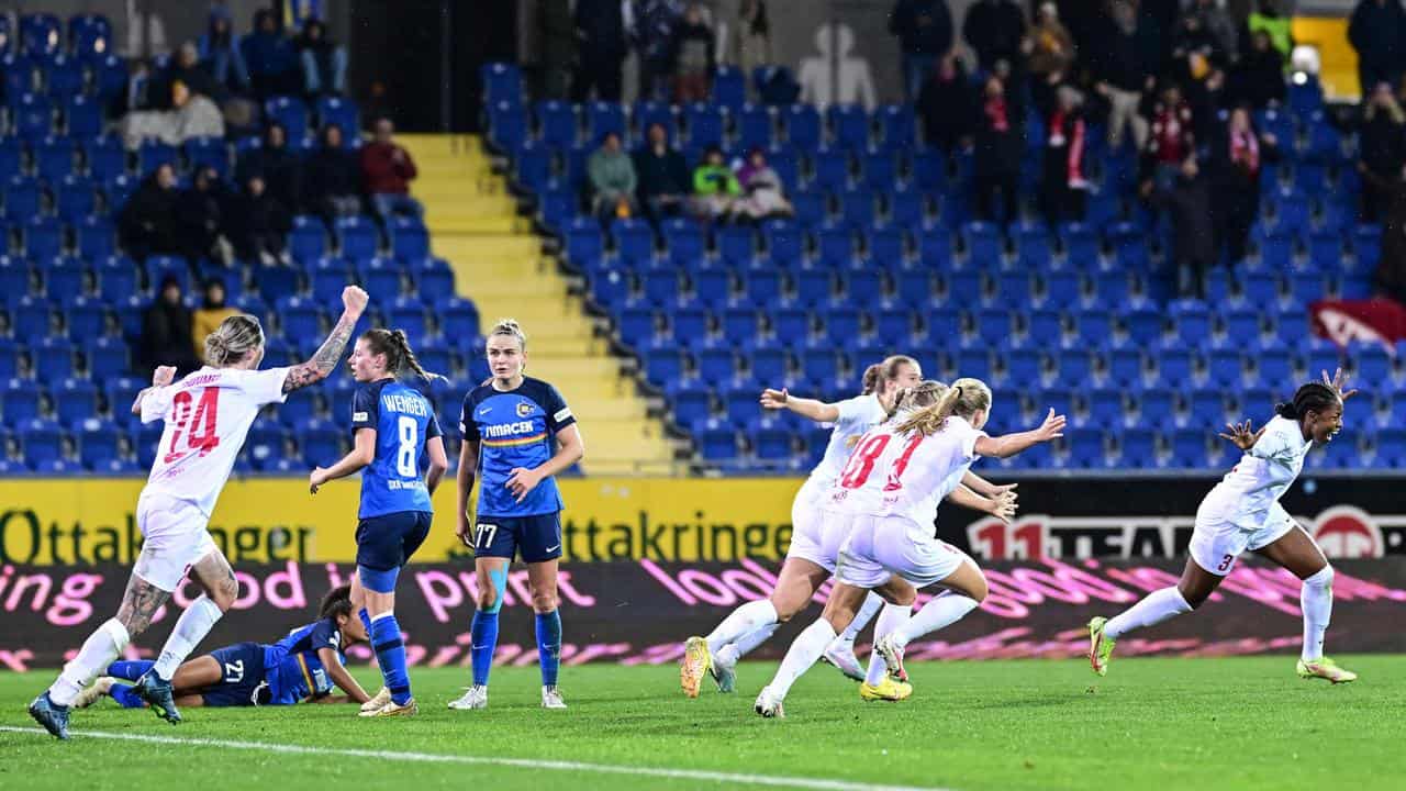 Brann players celebrate a goal.