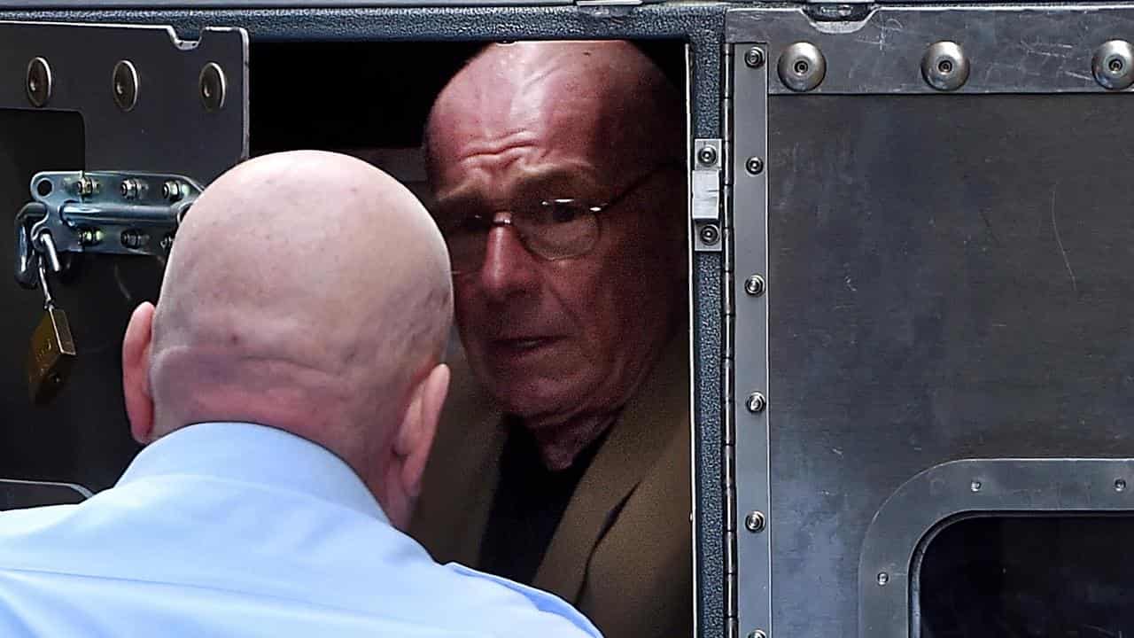 Roger Rogerson being escorted to a prison van 